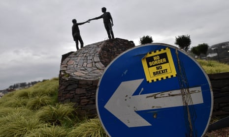 A ‘No Border, No Brexit’ campaign sticker on a road sign close to the Hands Across the Divide sculpture in Derry, Northern Ireland.