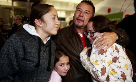 Fernando Arredondo of Guatemala reunites with his daughters Andrea, Keyli, and Alison, at Los Angeles international airport, 22 January 2020.