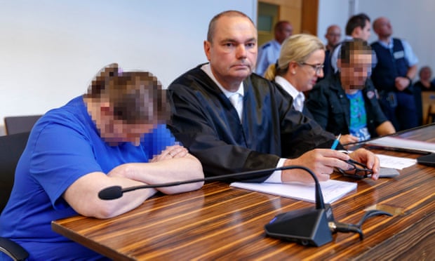 Berrin T (left) and Christian L (right) sit next to their lawyers