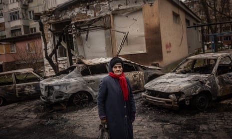 An elderly woman looks at damage caused by overnight Russian shelling of a residential building on 1 December in Kherson, Ukraine.