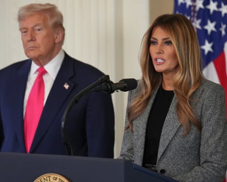 Donald Trump listens as first lady Melania Trump speaks during an executive order announcement.