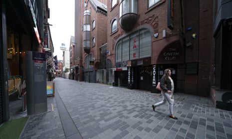 A woman walks past the closed Cavern Club in Liverpool on 16 October.
