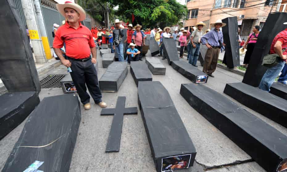 Members of the Peasant Unified Movement (Muca) of Bajo Aguán carry mock coffins bearing pictures of farmers killed in land conflict clashes, in Tegucigalpa, September 2012
