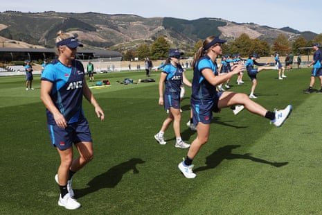 The White Ferns warm up against a backdrop of mountains.