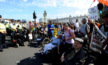 Protesters block part of Westminster Bridge in central London as they demonstrate against disability benefit cuts.