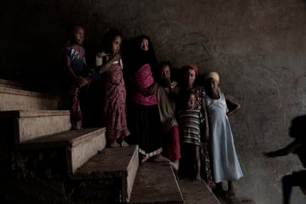 Girls pose for a photo at a school turned into a camp for displaced people in Khanfar, Yemen