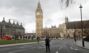 A armed police officer stands guard outside the Houses of Parliament.