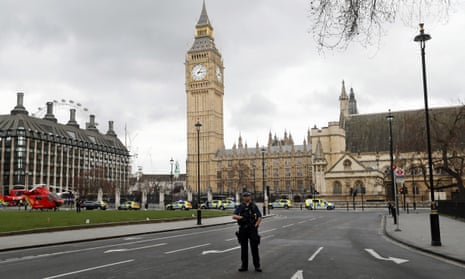 A armed police officer stands guard outside the Houses of Parliament.