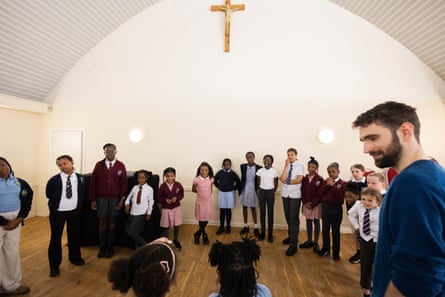 SJDK director of music Joe Tobin with members of St John the Divine girls choir