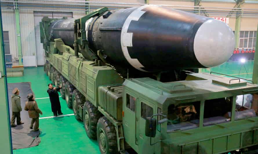 Kim Jong Un is seen with the newly developed intercontinental ballistic rocket Hwasong-15