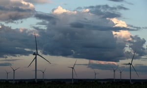 wind turbines under cloudy sky