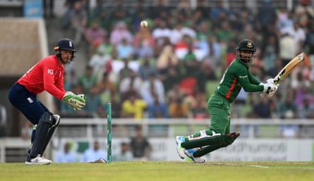 Litton Das of Bangladesh clips the ball away as Jos Buttler looks on