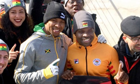 Anthony Watson (L) of Jamaica poses with Akwasi Frimpong (R) of Ghana after the men’s skeleton heats on day six of the Winter Olympic Games