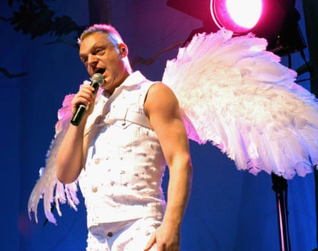 Andy Bell performing on stage in angel wings
