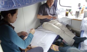 Travellers playing cards on a long-distance train from Kunming to Xiamen, China.