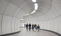 people rounding the bend of a curvaceous elizabeth line corridor