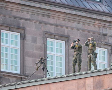 Armed security personnel stand guard during an informal summit between EU leaders at the Danish parliament.