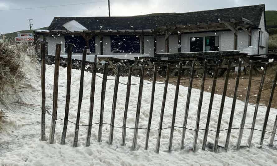 Poldhu Beach Cafe in Mullion, Cornwall, was covered in sea foam so thick it looked like snow.