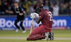 West Indies batsmen Carlos Brathwaite sinks to his knees as he is caught to end the match.