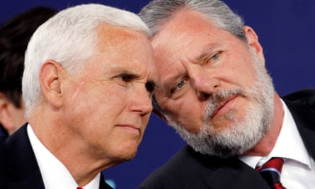 Jerry Falwell Jr confers with Mike Pence at Liberty University’s commencement ceremony in Lynchburg, Virginia on Saturday.