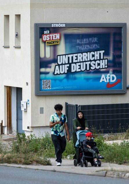 An AfD election billboard reads ‘The east is doing it: class in German’, in Altenburg, eastern Germany.