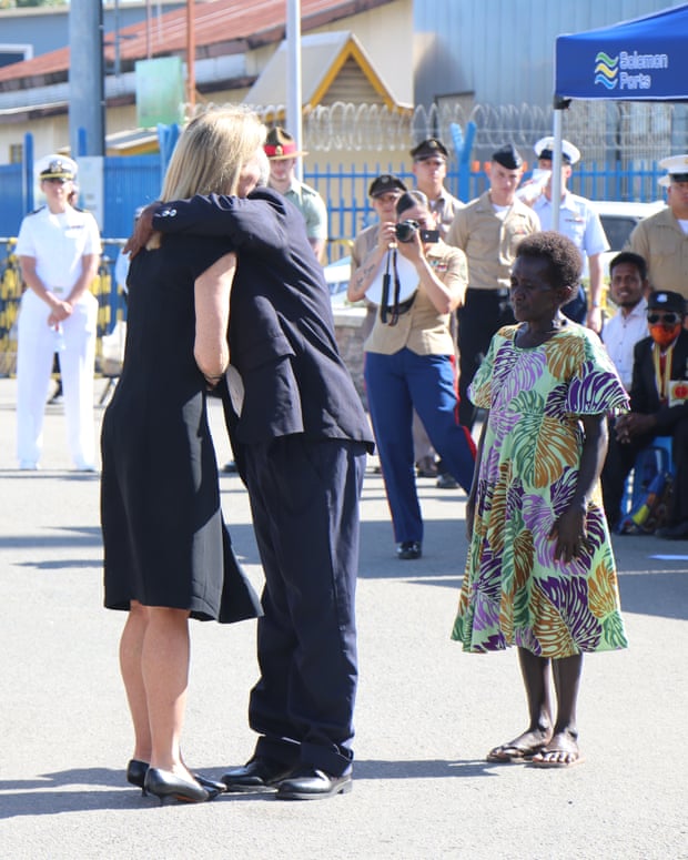 Caroline Kennedy, the US ambassador to Australia, hugs John Koloni, the son of Eroni Kumana, who helped rescue her father, JFK, during the second world war.