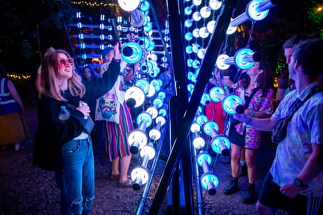 Revellers playing a light instrument at Woodsies.