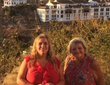 Faye Harrison and Liz Spooner standing outside, wearing summer dresses, smiling at the camera