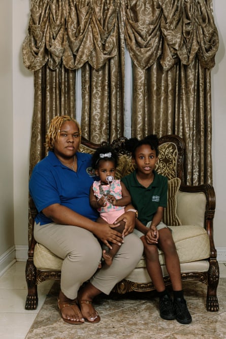 Sheena Dedmond sits at home with her daughters (L to R) Braylein and Baylei. Sheena has lived at the home in Gordon Plaza her entire life.