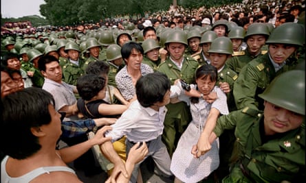 Amid growing tension, scuffles break out among protesters and security forces near the Great Hall of The People in June 1989.