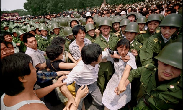Amid growing tension, scuffles break out among protesters and security forces near the Great Hall of The People in June 1989.