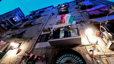 Coronavirus: quarantined Italians sing from balconies to lift spirits – video