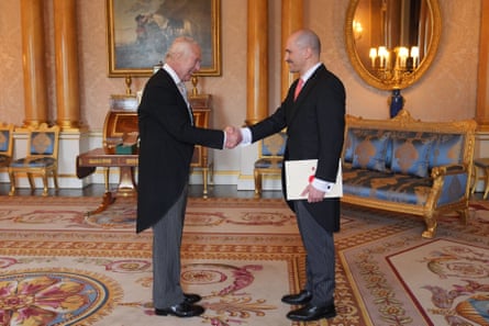 Uran Ferizi shakes hands with King Charles during a private audience at Buckingham Palace.
