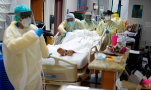 Healthcare workers move a patient in the Covid-19 Unit at United Memorial Medical Center in Houston.