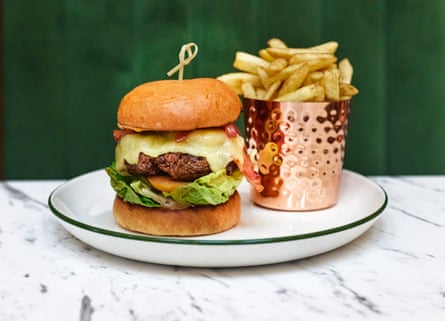 Dorothy and Marshall’s homemade Trenchmore beef burger on a toasted brioche bun with smoked bacon, melted cheddar and truffled fries.