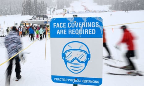 Signage requiring face coverings is displayed at a ski lift at Lake Louise ski resort in Alberta, Canada.