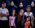 Wijdan Abu Matar poses with seven of her eight children, five girls and two boys of varying ages. The youngest is a girl of about five or six with three girls who appear to be from their mid to late teens.