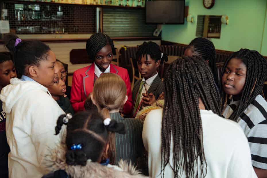 Christina Sowa-Opoku, in her red school uniform, discusses an upcoming performance during an after school session with Fame Star Youth in Woodberry Down Community Centre, 12th November, 2020.