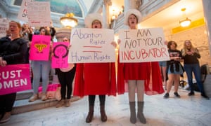 Women hold signs at rally to oppose recent abortion bans in the US