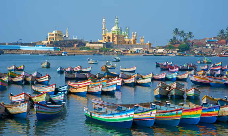 Colourful boats and a temple in the distance