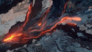Red lava flows from Mauna Loa volcano, Hawaii, in November, shown in a combination of day and night images