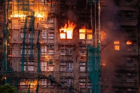 Bamboo scaffolding is visible around the complex as the fire spreads.