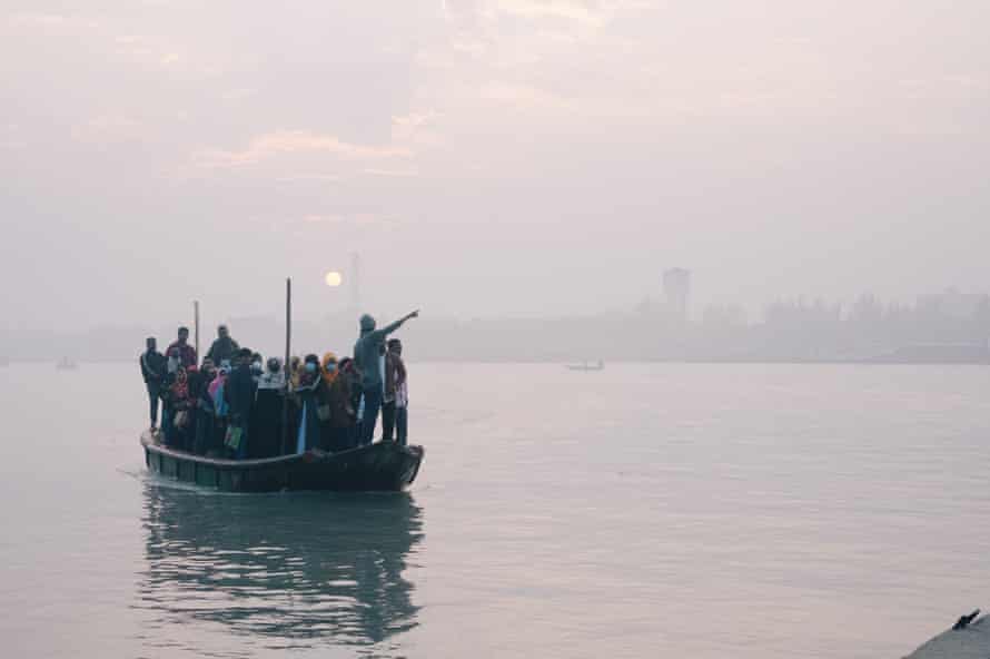 A boat carrying workers docks on the river in the port city of Mongla.