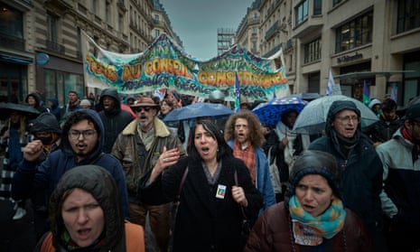 Protesters chant in the rain during a march through the centre of Paris on Friday.
