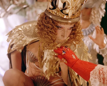 In The Devils, Graham Armitage plays Louis XIII in a gold costume and jewelled crown kisses a red-gloved hand