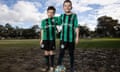 Enfield FC players Alexander and Sebastian Amendolia stand together on a muddy field with a football at their feet