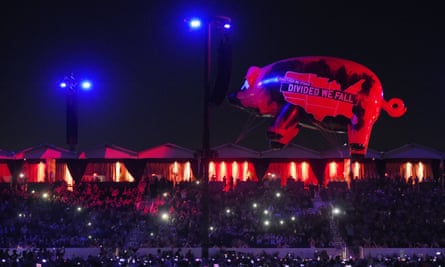 An inflatable pig carrying political slogans flies above the crowd at Empire Polo Club during Roger Waters’ closing set on 9 October.