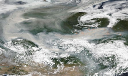 An image released by Nasa shows smoke from hundreds of forest fires covering most of Russia on 6 August