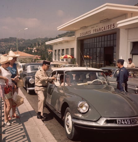 French customs officials check a car passing through the French, Italian border in 1975.