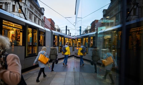 Commuters on Metrolink trams in Manchester. 